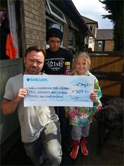 Wellingborough Homes presents cheque to Wellingborough Dog Welfare